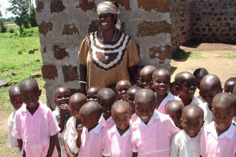 Smiling Kids acccompanied by their chaperone.